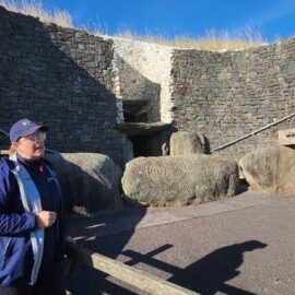 A docent outside Newgrange passage tomb