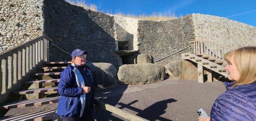 A docent outside Newgrange passage tomb