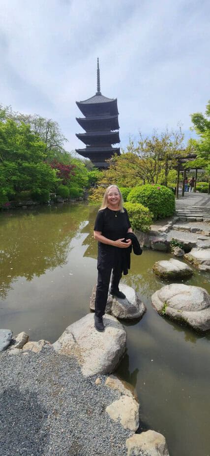 A zen garden like this one offers a quieter side of Japan. A five story pagoda with a stream in front of it with stepping stones